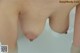 A close up of a woman's breasts in a bathtub.